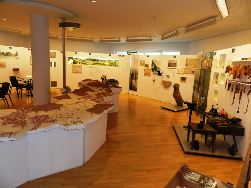 Innenansicht des Stadtmuseums, links eine große Gebietsansicht, rechs und im Hintergrund diverse Ausstellungsobjekte